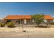 Single story home featuring a well-maintained yard, complemented by mature landscaping, and a charming fence at 2090 S Ambush St, Pahrump, NV 89048