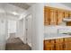 Hallway with carpet flooring and white walls and trim leads to the kitchen area at 2090 S Ambush St, Pahrump, NV 89048