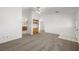 Cozy carpeted living room with access to the kitchen and an exterior door at 2090 S Ambush St, Pahrump, NV 89048