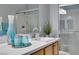Modern bathroom with decorative vases, a sleek sink, a glass-enclosed shower, and wood-finished cabinets at 2305 W Horizon Ridge Pkwy # 3713, Henderson, NV 89052