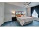Cozy bedroom showcases a decorative headboard, blue carpet, and window nook for a tranquil and relaxing space at 2305 W Horizon Ridge Pkwy # 3713, Henderson, NV 89052