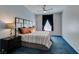 Inviting bedroom featuring blue carpet, a decorative headboard, and stylish curtains offering a serene retreat at 2305 W Horizon Ridge Pkwy # 3713, Henderson, NV 89052