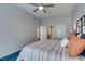 Spacious bedroom with a ceiling fan, soft blue carpet, white trim, and an ensuite bathroom at 2305 W Horizon Ridge Pkwy # 3713, Henderson, NV 89052