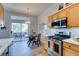 Bright kitchen with wood cabinets, stainless steel appliances, and a dining area near sliding doors to the outdoor seating area at 2305 W Horizon Ridge Pkwy # 3713, Henderson, NV 89052