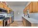 Well-equipped kitchen with stainless steel appliances, wood cabinets, and a white subway tile backsplash offering style and convenience at 2305 W Horizon Ridge Pkwy # 3713, Henderson, NV 89052