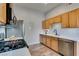 Functional kitchen featuring stainless steel appliances, wood cabinets, and a white subway tile backsplash for modern cooking needs at 2305 W Horizon Ridge Pkwy # 3713, Henderson, NV 89052