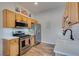 Efficient kitchen showcasing stainless steel appliances, wood cabinetry, and white subway tile backsplash, creating a modern cooking space at 2305 W Horizon Ridge Pkwy # 3713, Henderson, NV 89052