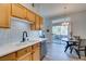 Bright kitchen and dining area with wood cabinets, stainless steel appliances, and sliding glass doors to a patio at 2305 W Horizon Ridge Pkwy # 3713, Henderson, NV 89052