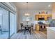 Dining area with backyard access, stainless appliances, wood cabinets, and a modern chandelier at 2305 W Horizon Ridge Pkwy # 3713, Henderson, NV 89052