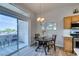 Dining area has an outdoor balcony and stainless appliances and wood cabinets in the kitchen at 2305 W Horizon Ridge Pkwy # 3713, Henderson, NV 89052