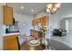 Kitchen and dining area with wood cabinets, stainless appliances, and modern lighting at 2305 W Horizon Ridge Pkwy # 3713, Henderson, NV 89052