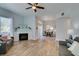 Bright living room featuring wood-look floors, a modern fireplace, and dining area at 2305 W Horizon Ridge Pkwy # 3713, Henderson, NV 89052