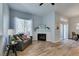 Cozy living room with natural light, wood-look flooring, a fireplace, and neutral paint at 2305 W Horizon Ridge Pkwy # 3713, Henderson, NV 89052