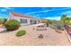 Landscaped backyard featuring drought resistant plants, covered patio, and tiled roof at 2377 Baldwinville Ct, Henderson, NV 89044