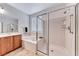 Bright bathroom featuring separate tub and shower, double sinks, and a large window for natural light at 2377 Baldwinville Ct, Henderson, NV 89044