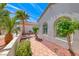Attractive exterior with arched windows, well-maintained landscaping, and a tiled walkway at 2377 Baldwinville Ct, Henderson, NV 89044