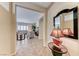 Elegant foyer with tiled floors, a decorative mirror, and a glimpse into the living room at 2377 Baldwinville Ct, Henderson, NV 89044