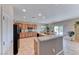 Eat-in kitchen features an island with bar seating, granite counters, and stainless appliances at 2377 Baldwinville Ct, Henderson, NV 89044