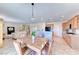 Spacious eat-in kitchen and living room boasts an island with granite counters and stainless appliances at 2377 Baldwinville Ct, Henderson, NV 89044