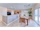 Bright eat-in kitchen with stainless steel appliances, light wood cabinets, and backyard access at 2377 Baldwinville Ct, Henderson, NV 89044