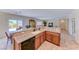 Eat-in kitchen features an island with bar seating, granite counters, and stainless appliances at 2377 Baldwinville Ct, Henderson, NV 89044