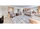 Open-concept living room featuring neutral tones, tile flooring, and abundant natural light at 2377 Baldwinville Ct, Henderson, NV 89044