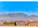 Picturesque mountain view as seen over the rooftops, highlighting the serene desert setting at 2377 Baldwinville Ct, Henderson, NV 89044
