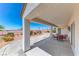 Covered patio with chairs and table, with views of the desert landscaping and mountains at 2377 Baldwinville Ct, Henderson, NV 89044
