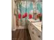 Bathroom features dual sinks and vibrant, eye catching shower curtain at 2559 Purple Heather Pl, Henderson, NV 89052