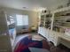 Bedroom with bunkbeds, large shelving unit and cozy chair at 2559 Purple Heather Pl, Henderson, NV 89052