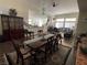 Spacious dining room features a long wood table, chandelier and vintage china cabinet at 2559 Purple Heather Pl, Henderson, NV 89052