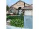 Beautiful home with lush landscaping, including roses, and a convenient two-car garage at 2559 Purple Heather Pl, Henderson, NV 89052