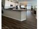Modern kitchen featuring sleek black countertops and hardwood flooring, perfect for cooking at 2559 Purple Heather Pl, Henderson, NV 89052