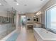 Spacious bathroom featuring a glass shower, a soaking tub and vanity with views at 26 Olympia Outlook Dr, Las Vegas, NV 89141