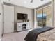 Comfortable bedroom with balcony access, a stylish cabinet, and soft neutral tones for a relaxing ambiance at 26 Olympia Outlook Dr, Las Vegas, NV 89141