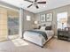 Cozy bedroom with a decorative ceiling fan, plush carpeting, and large sliding doors to private balcony at 26 Olympia Outlook Dr, Las Vegas, NV 89141