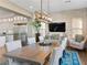 Beautiful dining area with a long wooden table, stone accent wall and modern light fixture at 26 Olympia Outlook Dr, Las Vegas, NV 89141