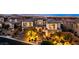 Elegant two-story home with manicured landscaping and illuminated driveway; luxurious curb appeal at 26 Olympia Outlook Dr, Las Vegas, NV 89141