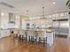 Spacious kitchen with large island, modern stainless steel appliances, and hardwood floors at 26 Olympia Outlook Dr, Las Vegas, NV 89141