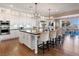 Bright, open kitchen featuring a center island, stainless steel appliances, and hardwood floors at 26 Olympia Outlook Dr, Las Vegas, NV 89141