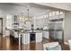 Spacious kitchen with large island, wine fridge, stainless steel appliances, and bright white cabinets at 26 Olympia Outlook Dr, Las Vegas, NV 89141