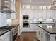 Modern kitchen with stainless steel appliances, quartz countertops, and custom white cabinetry at 26 Olympia Outlook Dr, Las Vegas, NV 89141
