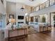 Bright living room with a two-story ceiling, modern fireplace, and views from large windows at 26 Olympia Outlook Dr, Las Vegas, NV 89141