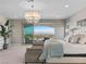 Spacious primary bedroom with balcony access and stunning views of the Las Vegas skyline at 26 Olympia Outlook Dr, Las Vegas, NV 89141