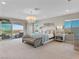 Spacious primary bedroom with a sitting area, balcony access, and stunning views at 26 Olympia Outlook Dr, Las Vegas, NV 89141