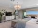 Bright main bedroom featuring a chandelier, sliding glass doors, and scenic views at 26 Olympia Outlook Dr, Las Vegas, NV 89141