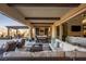 Spacious outdoor living area with comfortable seating, a dining table, and a ceiling fan at 26 Olympia Outlook Dr, Las Vegas, NV 89141
