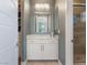 Bright powder room featuring modern vanity, great lighting and a tiled shower at 26 Olympia Outlook Dr, Las Vegas, NV 89141