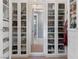 Walk-in closet features custom shelving, mirrored cabinets and great lighting at 26 Olympia Outlook Dr, Las Vegas, NV 89141