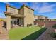 Backyard featuring artificial turf, a covered patio, and a privacy wall at 2849 Mincio St, Henderson, NV 89044